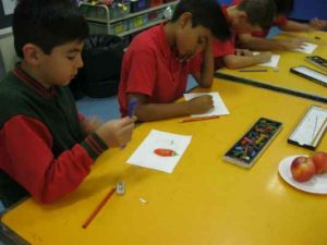 Grade 3 and 4 students exploring new techniques to create textured drawings.